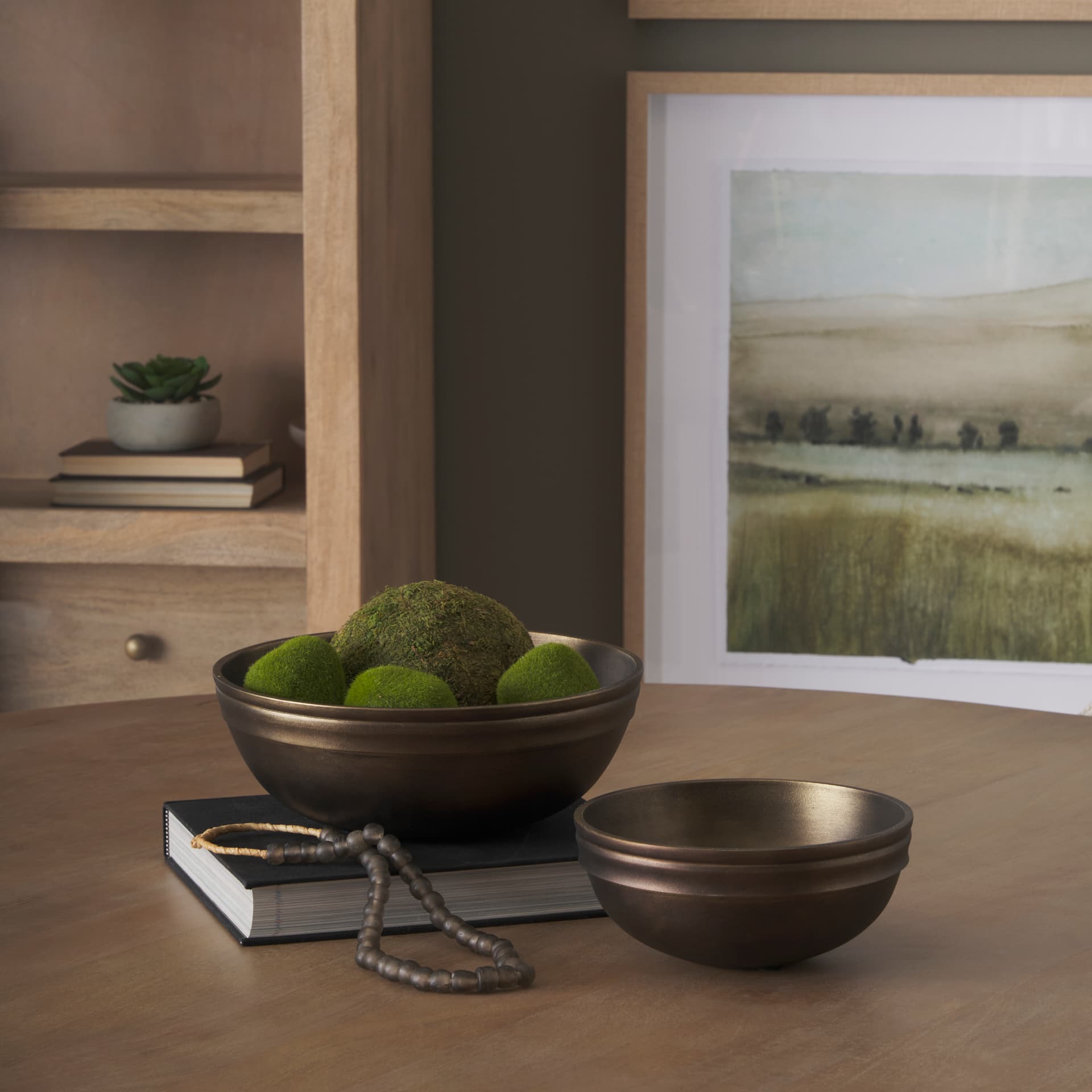 Tomiko Decorative Brass Finished Cast Aluminum Round Bowls — in a styled room