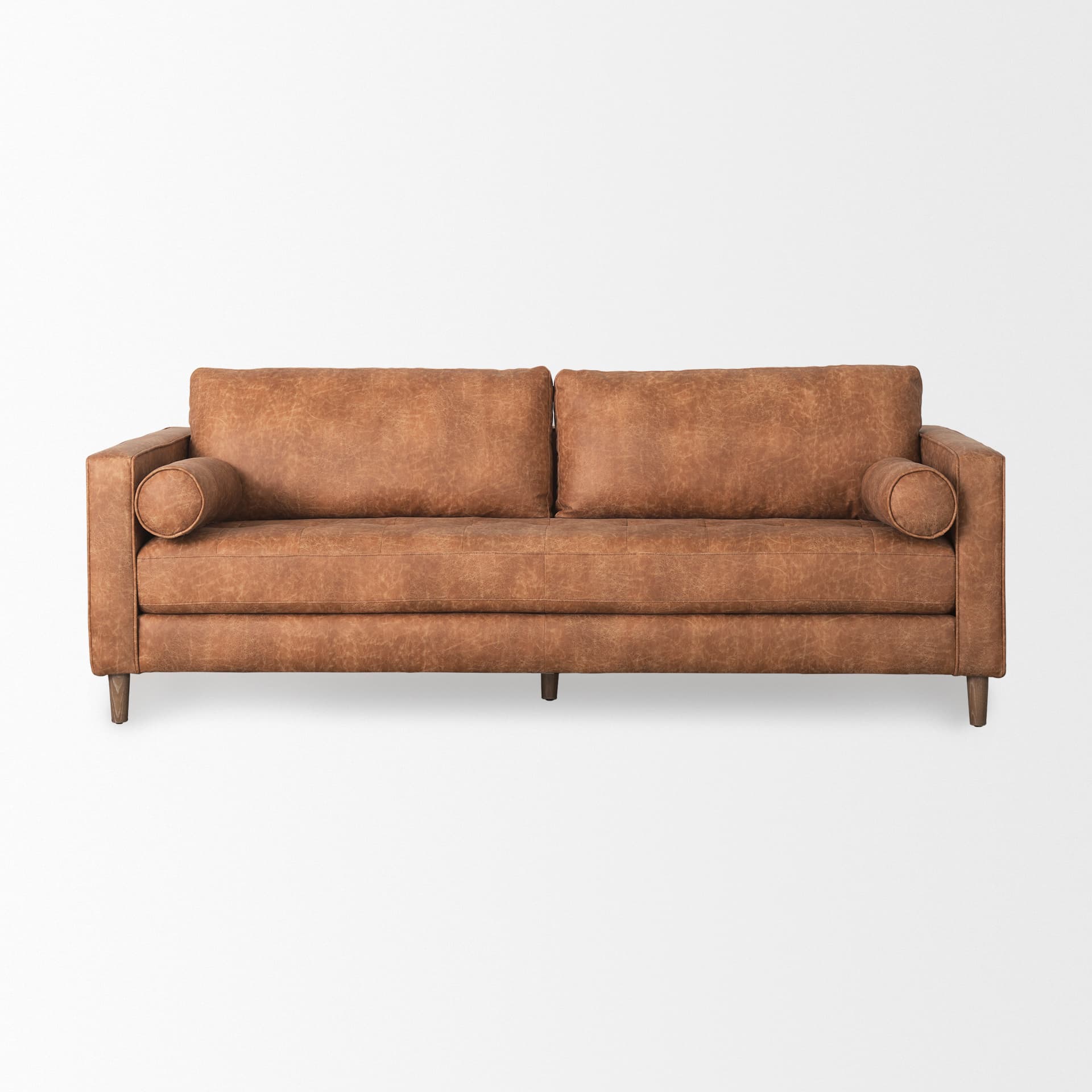 Loretta 88.0L x 36.2W x 33.9H Cognac Brown Faux Leather Three Seater Sofa with Two Bolster Cushions — product photograph