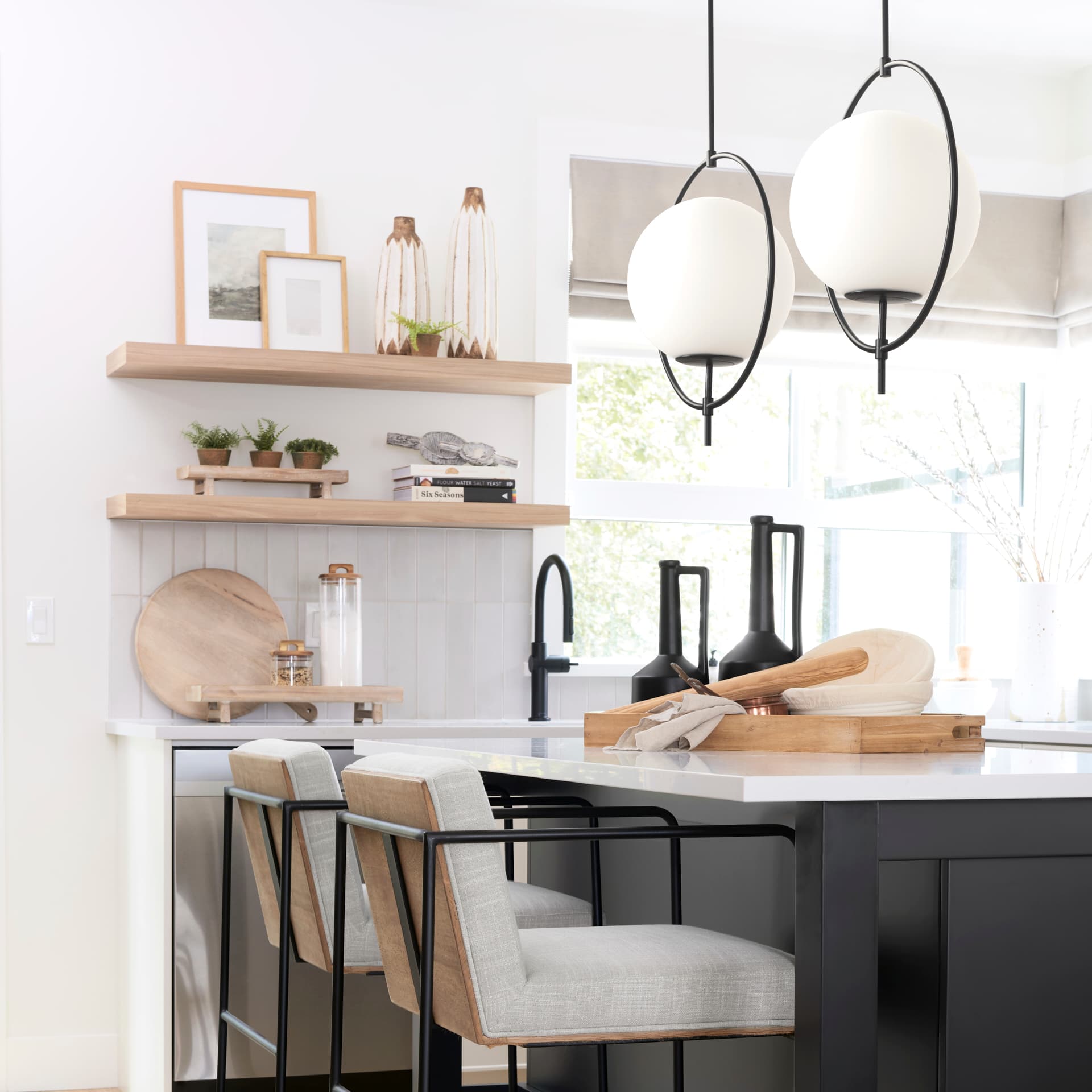 Farrah Frosted Glass Globe set in Matte Black Metal Pendant Ceiling Light — in a styled room