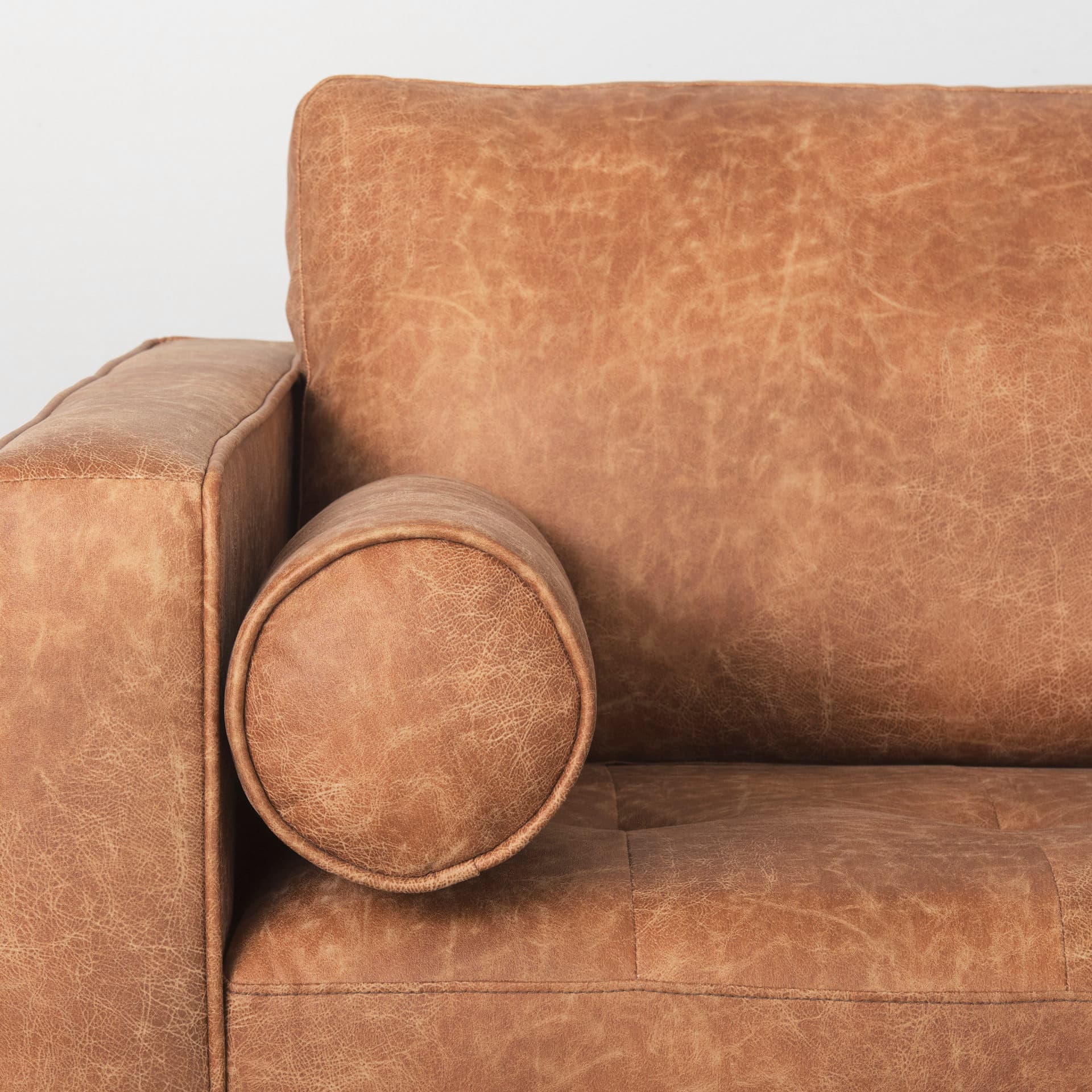 Loretta 88.0L x 36.2W x 33.9H Cognac Brown Faux Leather Three Seater Sofa with Two Bolster Cushions — product photograph