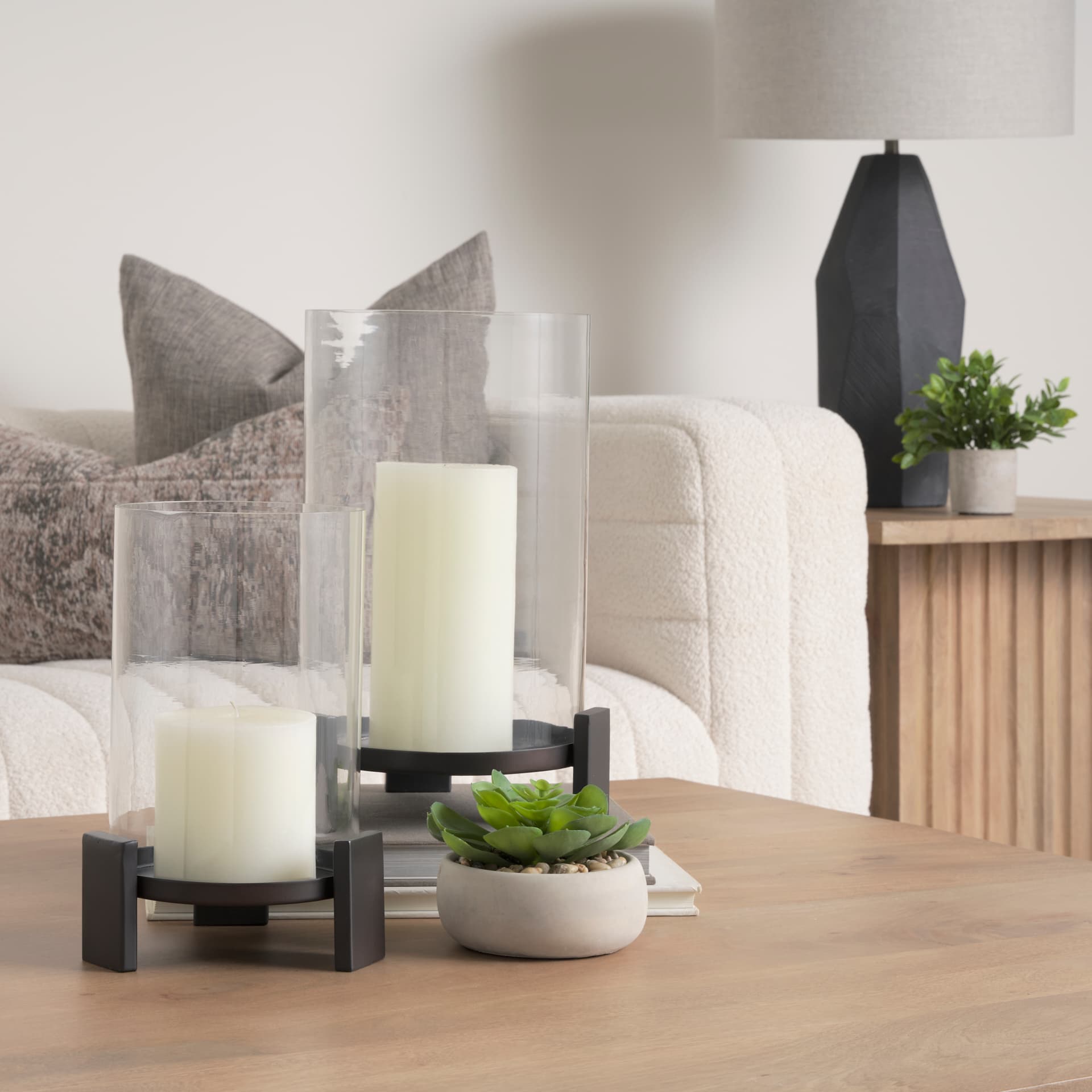 Price Small Matte Black-Brown Metal w/ Glass Hurricane Candle Holder — in a styled room