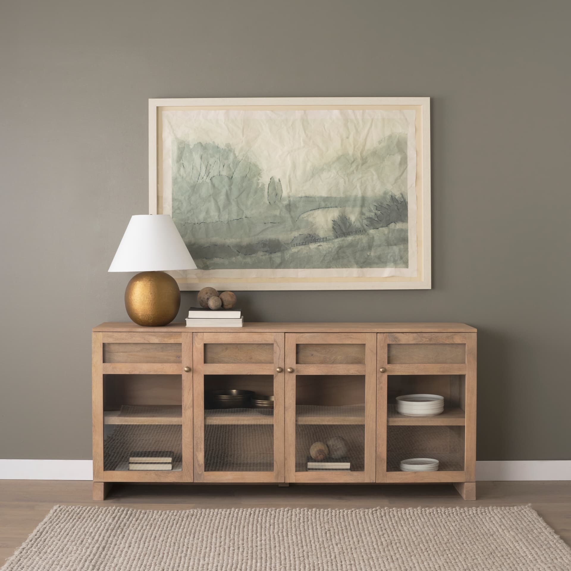 Sadiyah Antiqued Gold Brushed Metal w/ Cream Shade Table Lamp — in a styled room