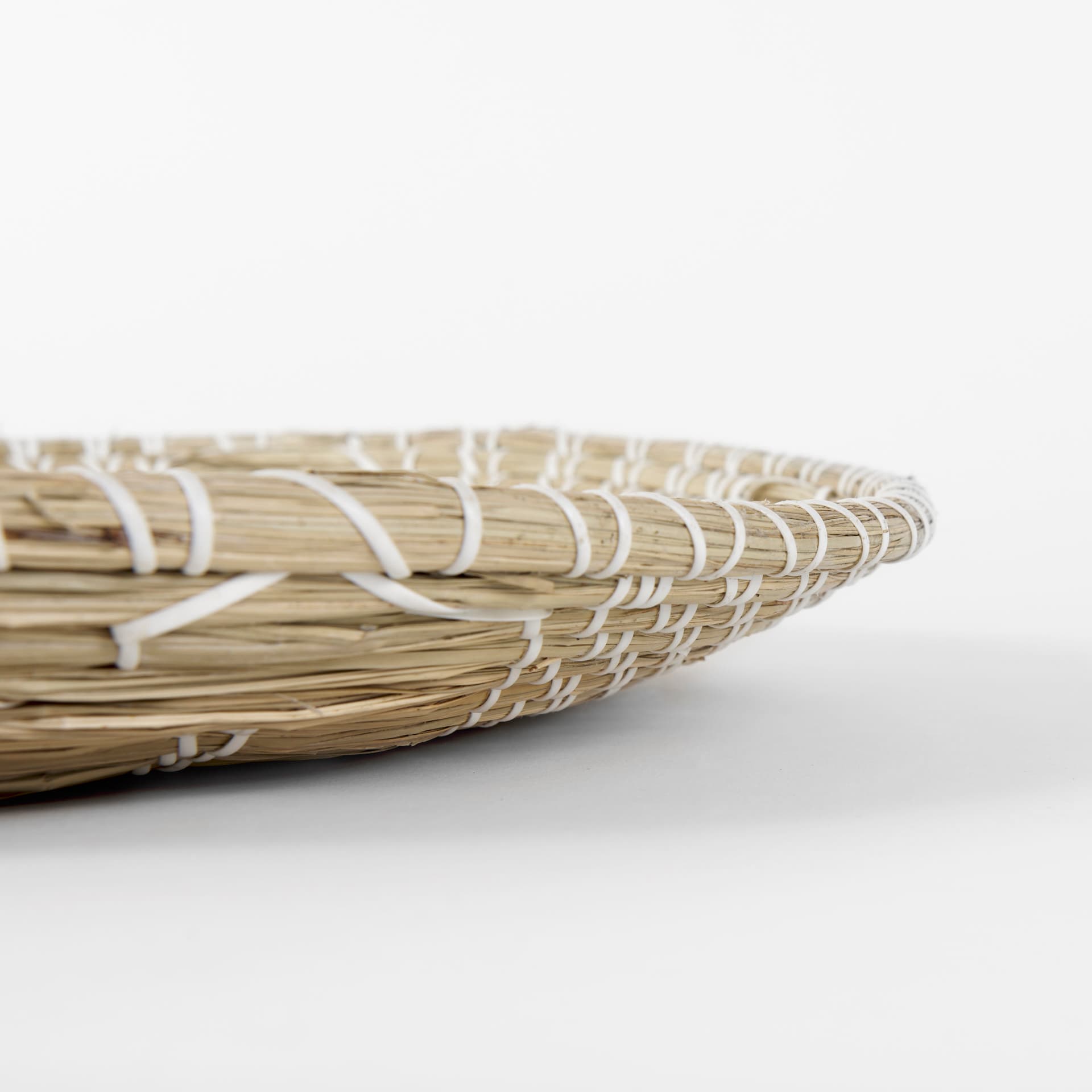 Mekhi 24.0L x 24.0W x 3.5 Light Brown Seagrass W/White String Round Wall Hanging Plate — product photograph