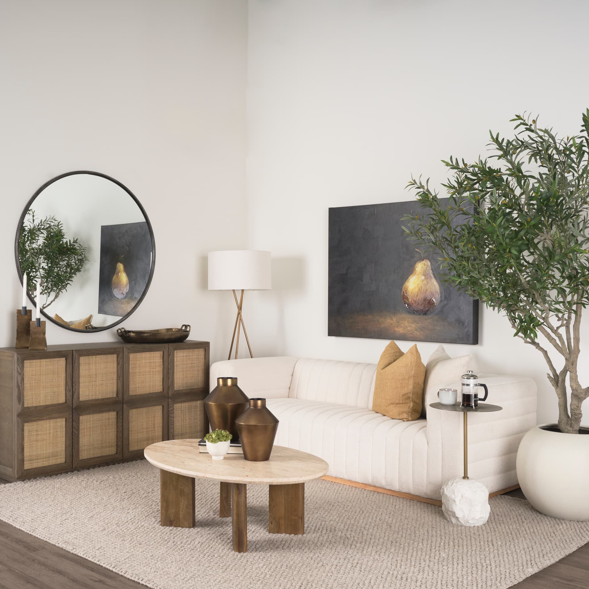 Syona Travertine + Mango Wood leg Oval Coffee table — in a styled room