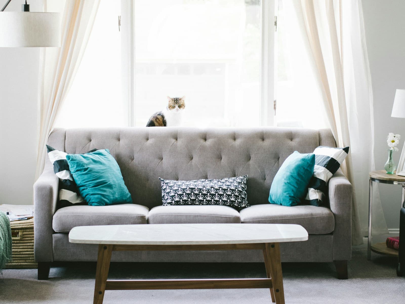 Aster three-seat sofa in oat bouclé, angled against a pale wall