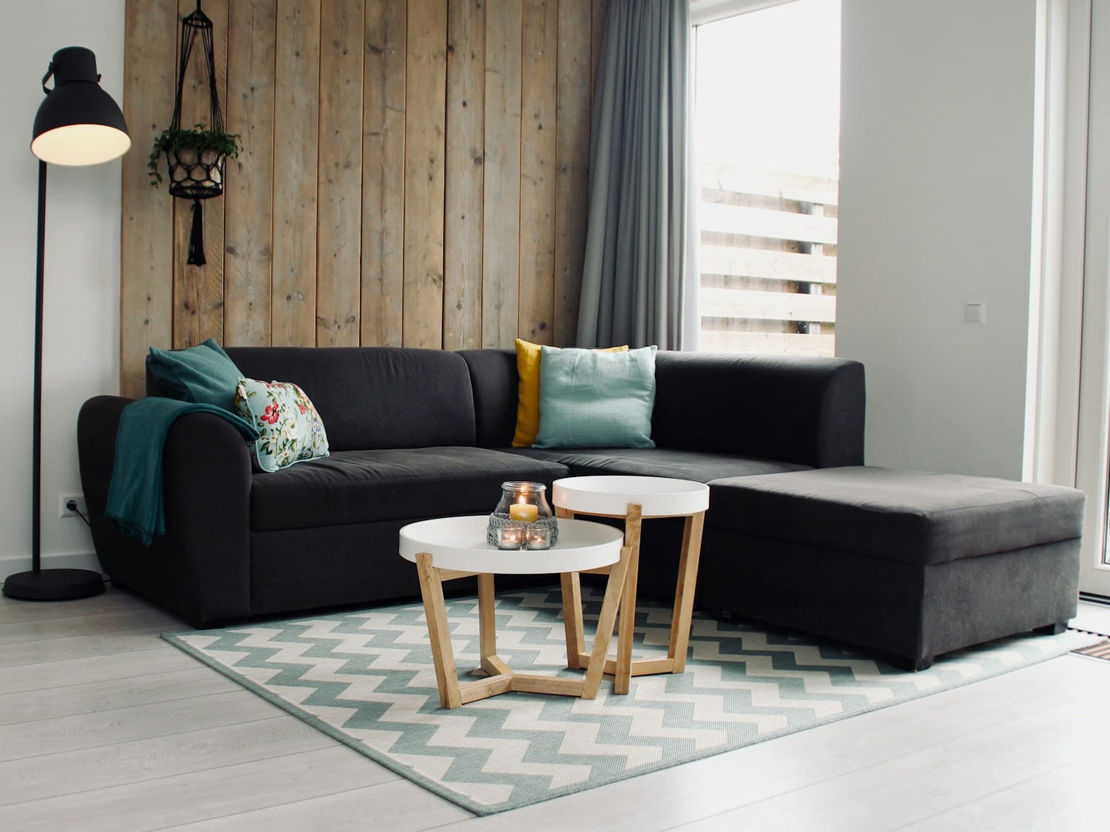 Aster three-seat sofa in charcoal wool, in a living room