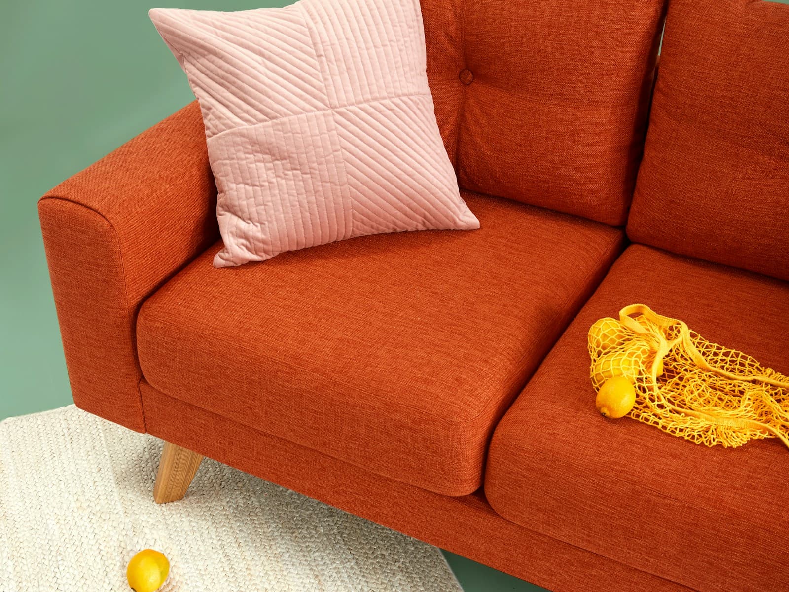 Aster three-seat sofa in rust velvet, seat and arm detail