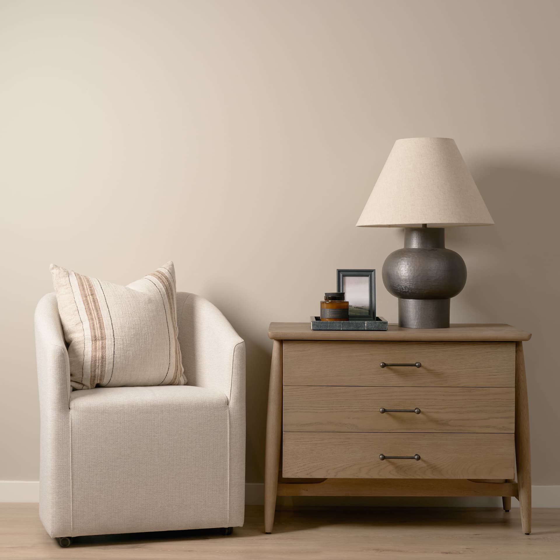 Hollis Gray-Brown Wood 3-Drawer Closed Nightstand — in a styled room