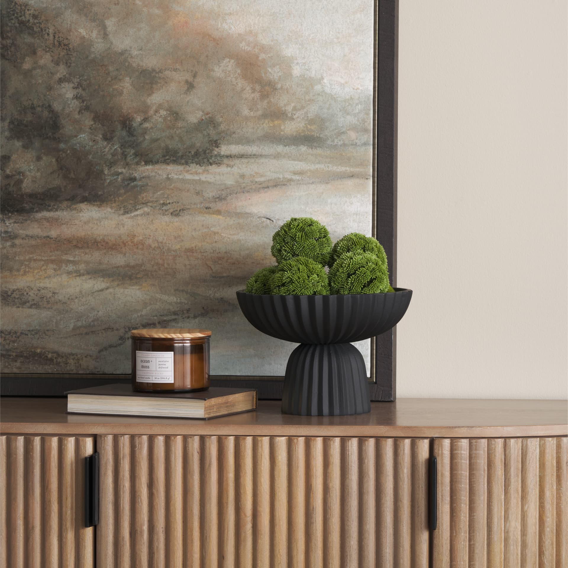 Ciaran Smooth Fluted Matte Black Metal Decorative Bowl — in a styled room
