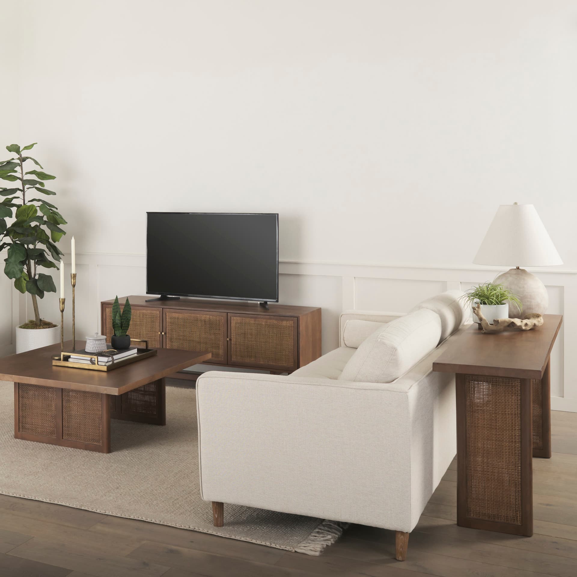 Grier 65" Medium Brown Solid Wood w/ Cane Console Table — in a styled room