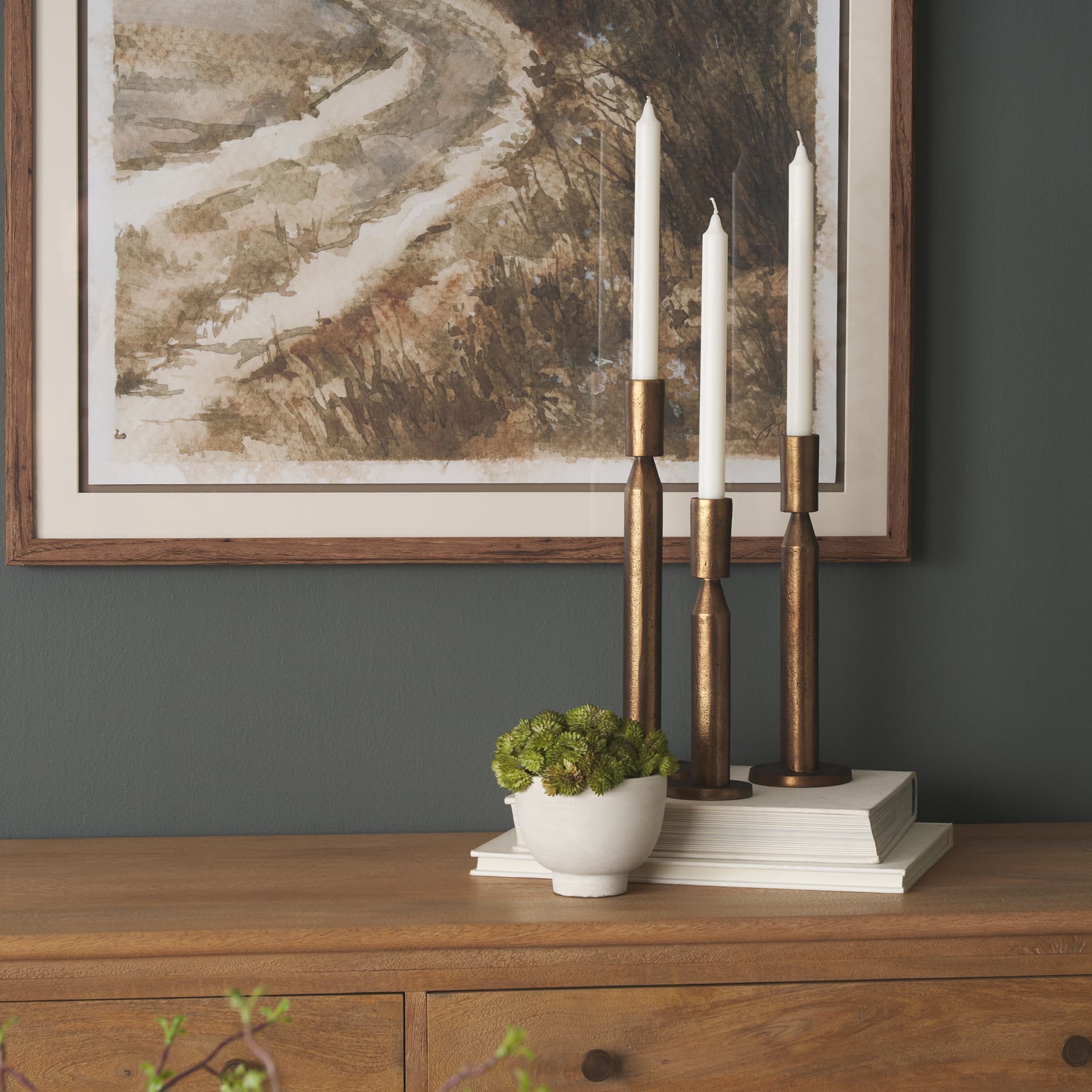 Declan Antiqued Brass Cast Metal Taper Candle Holder — in a styled room