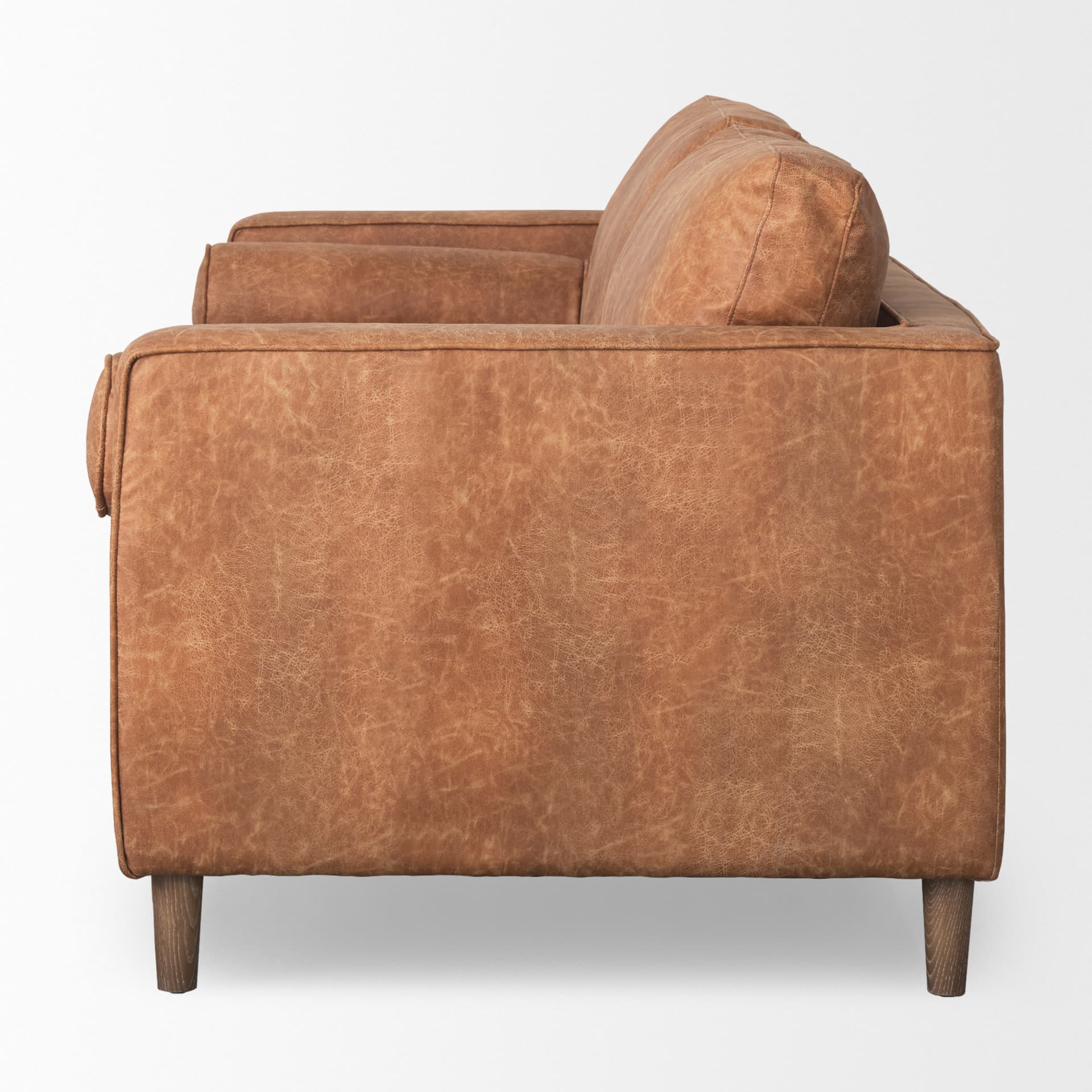 Loretta 88.0L x 36.2W x 33.9H Cognac Brown Faux Leather Three Seater Sofa with Two Bolster Cushions — product photograph