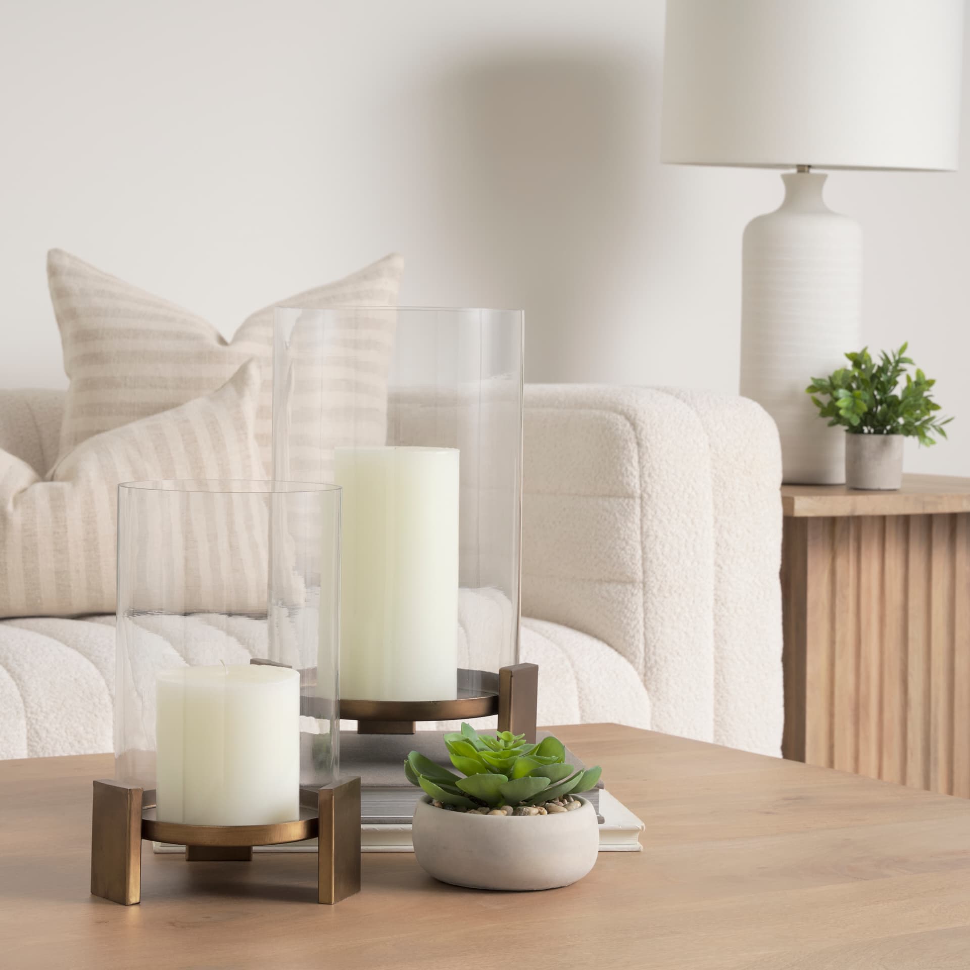 Price Large Antiqued Gold Metal w/ Glass Hurricane Candle Holder — in a styled room