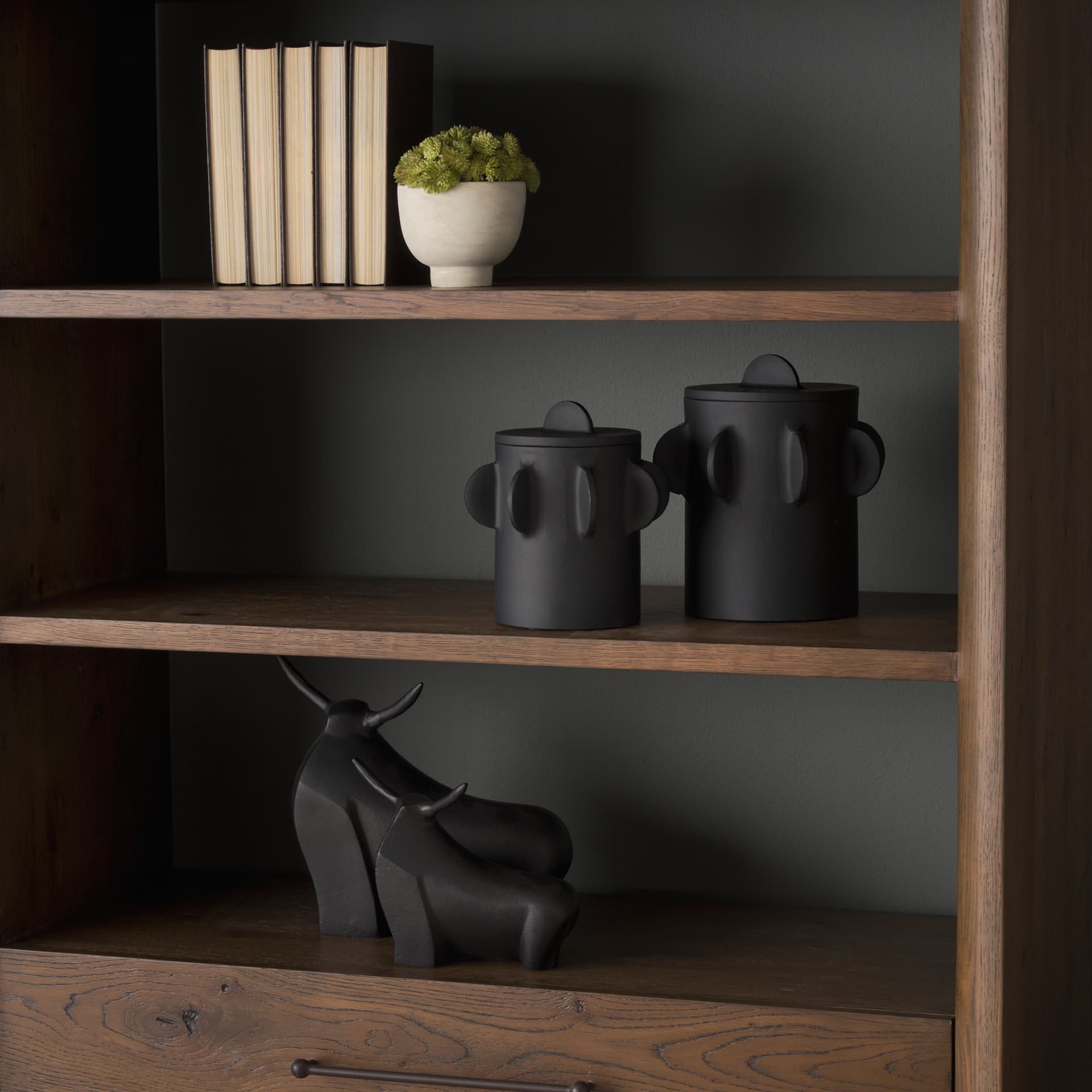 Deacon Large Matte Black Metal Canister with Sculptural Handles — in a styled room