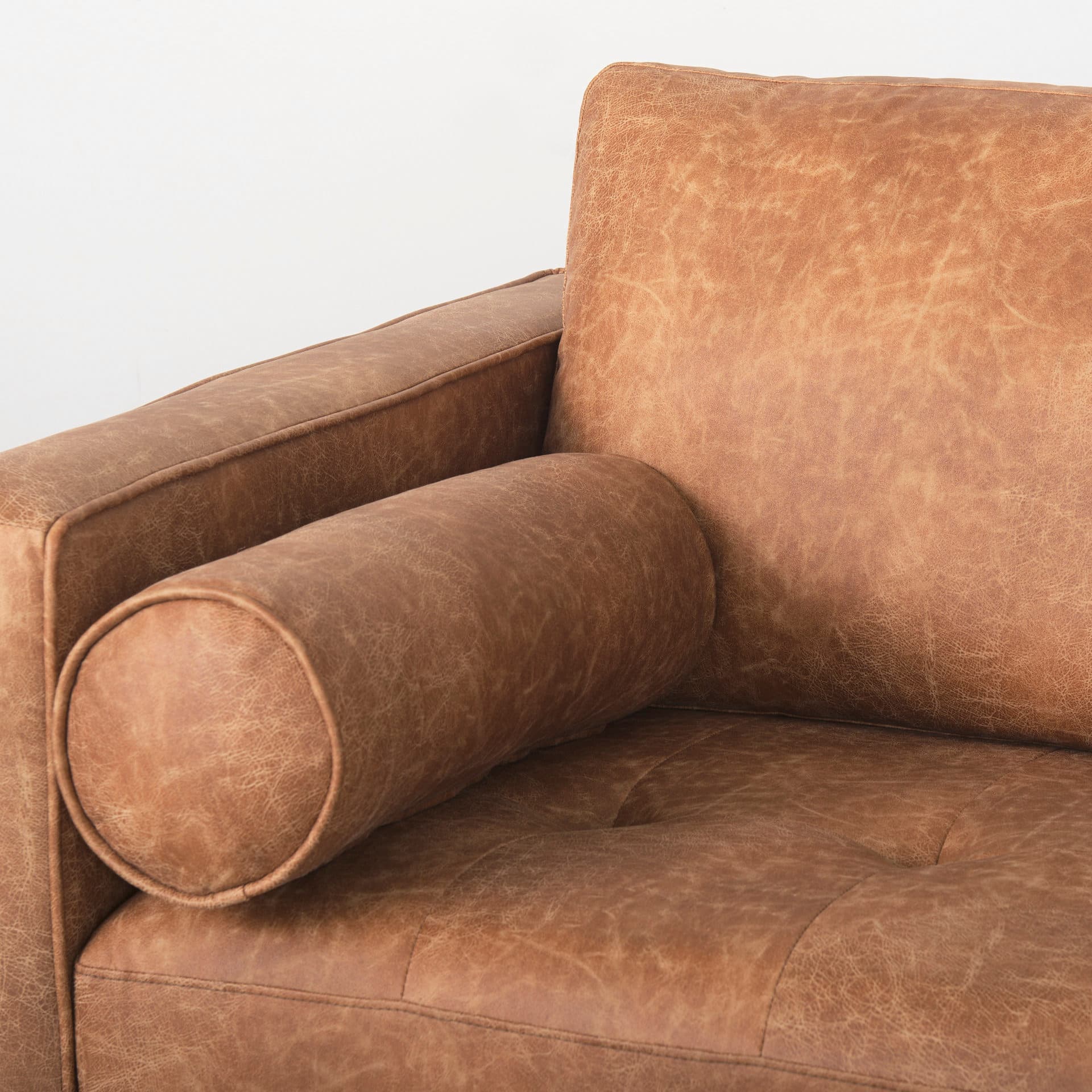 Loretta 88.0L x 36.2W x 33.9H Cognac Brown Faux Leather Three Seater Sofa with Two Bolster Cushions — product photograph