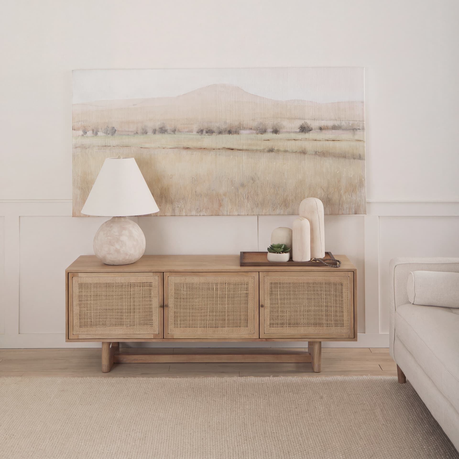 Grier 65" Light Brown Wood w/ Cane Media Console — in a styled room