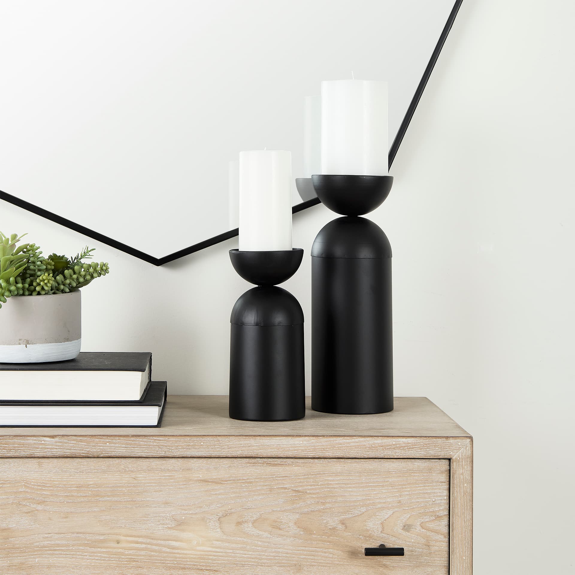 Alex Small Black Metal Cylindrical Table Candle Holder — in a styled room