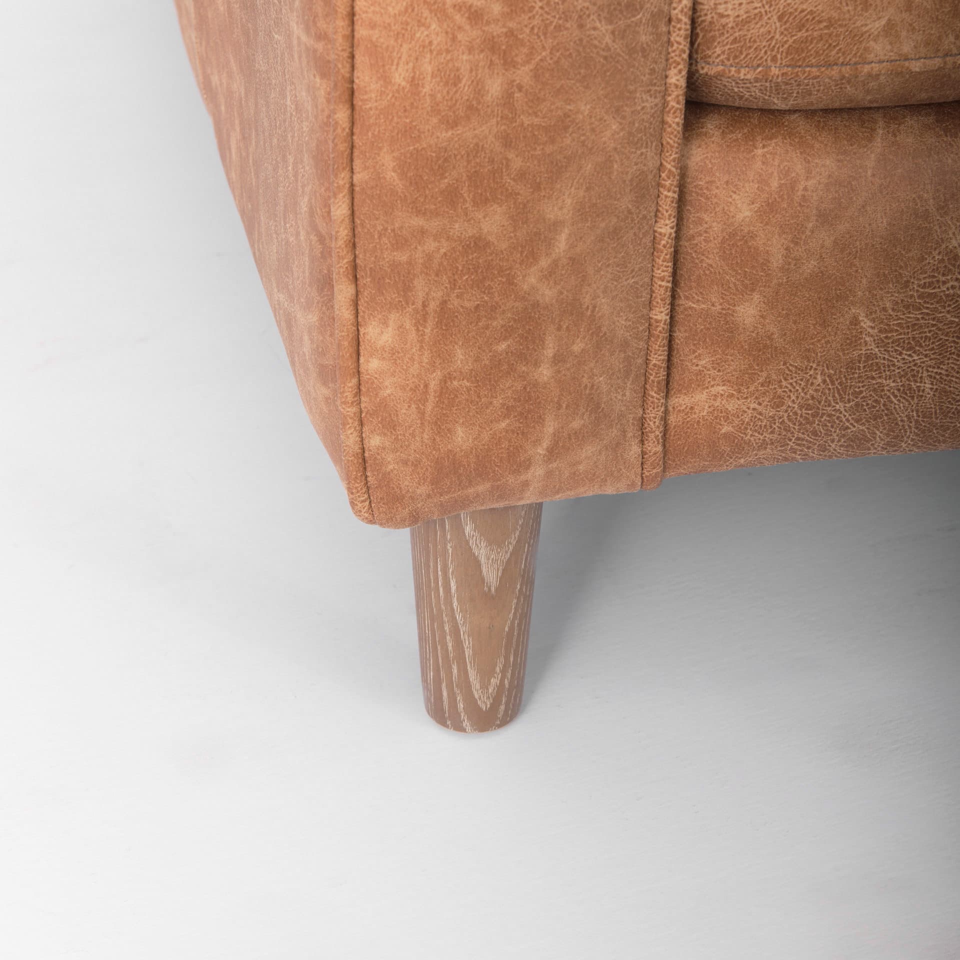 Loretta 88.0L x 36.2W x 33.9H Cognac Brown Faux Leather Three Seater Sofa with Two Bolster Cushions — product photograph