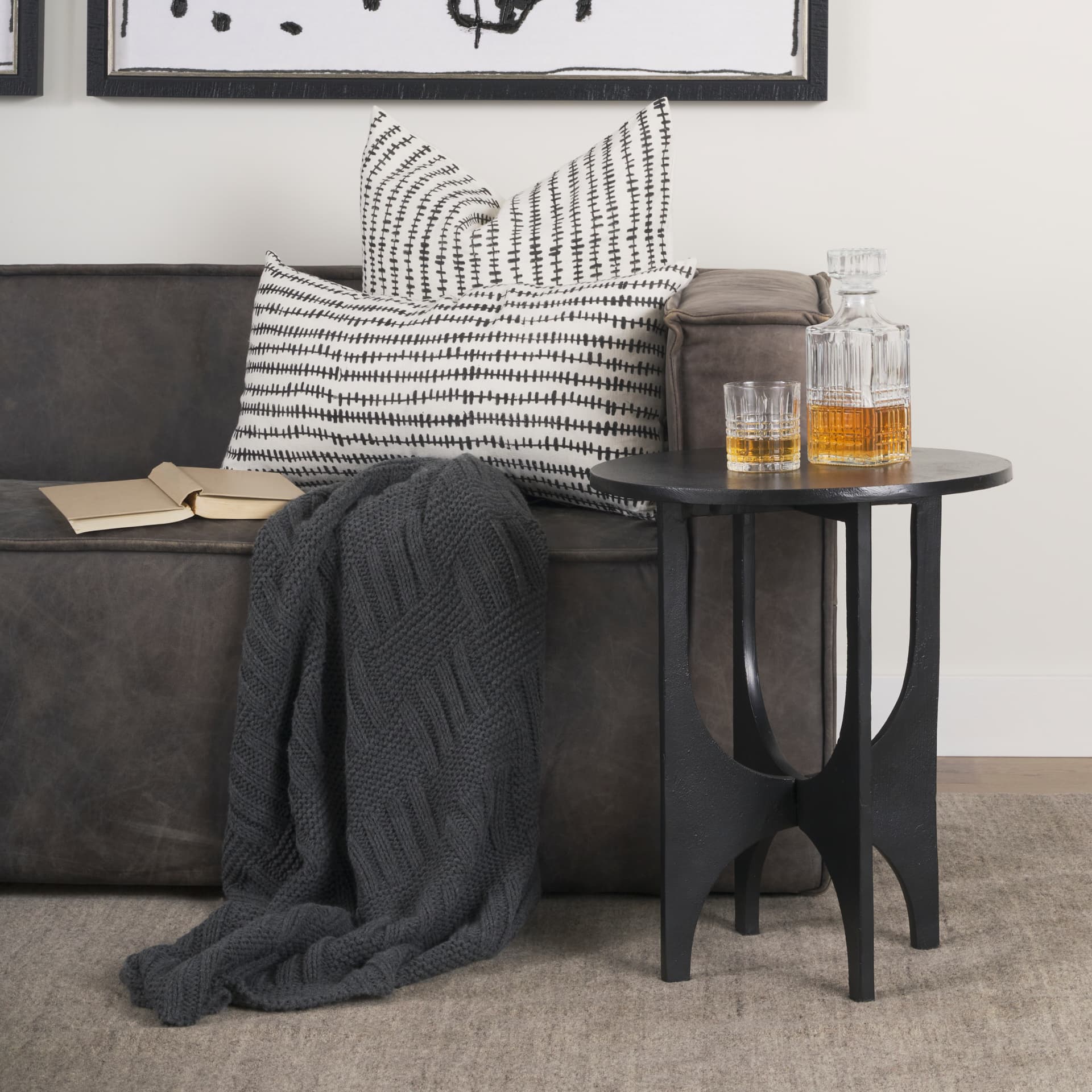 Sobi Textured Matte Black Round Metal Accent Table — in a styled room
