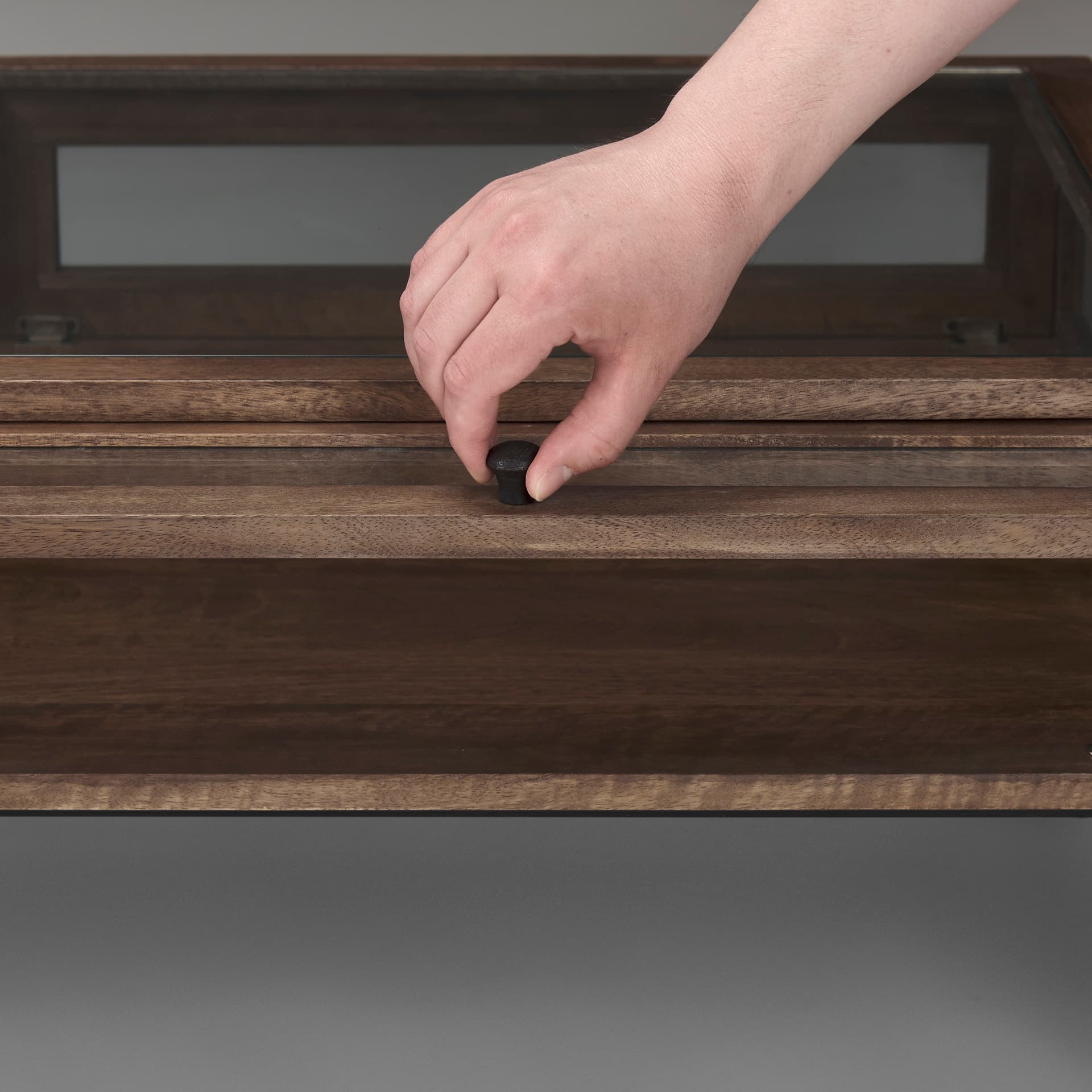Arelius 49.5"L Rectangular Glass-Top Medium Brown Wood w/ Black Metal Base Display Coffee Table — product photograph