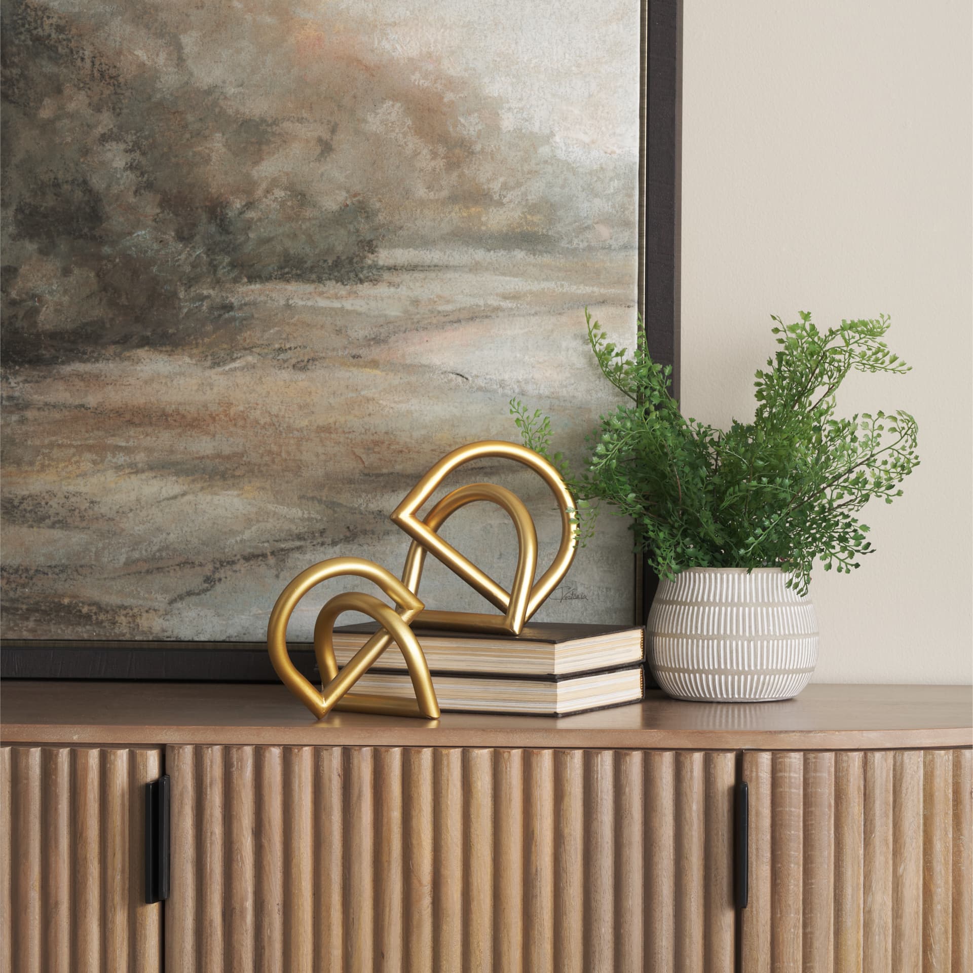Locke Small Matte Gold Metal Decorative Object — in a styled room