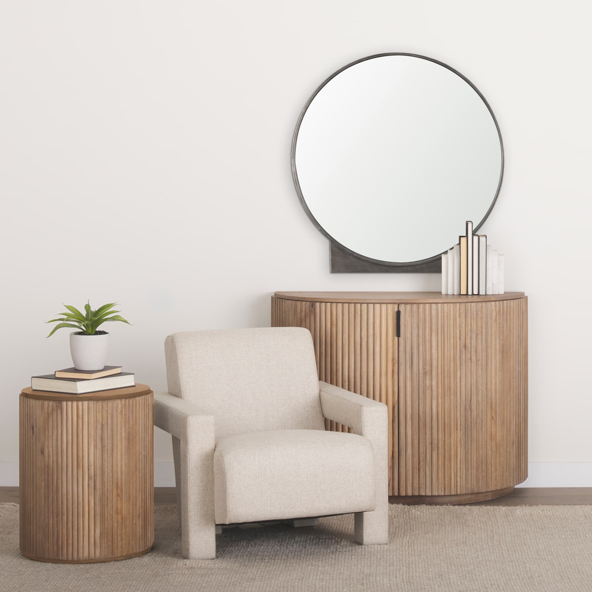 Tillie Round Gunmetal w/ Textured Metal Frame Wall Mirror — in a styled room