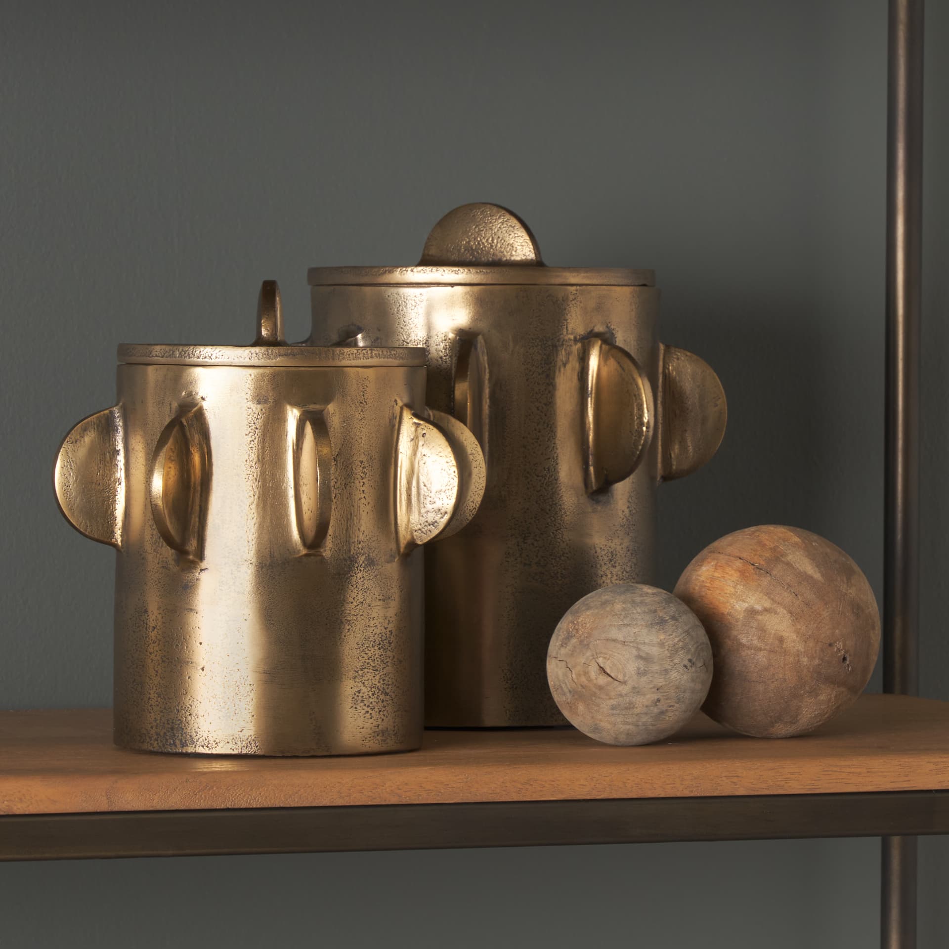 Deacon Large Antiqued Gold Metal Canister with Sculptural Handles — in a styled room