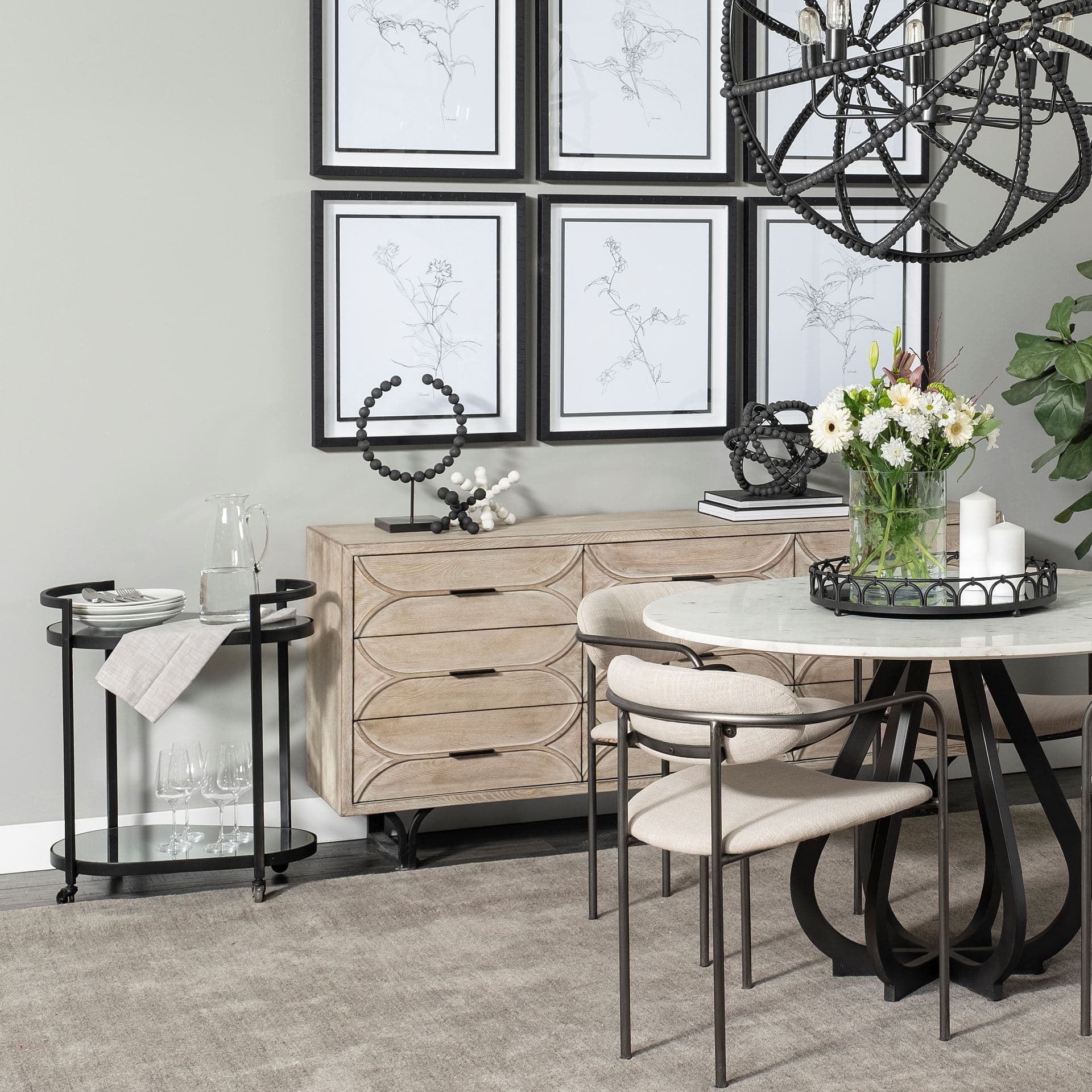 Eleonore Black Metal Frame Two-Tier w/Glass Shelves Bar Cart — in a styled room