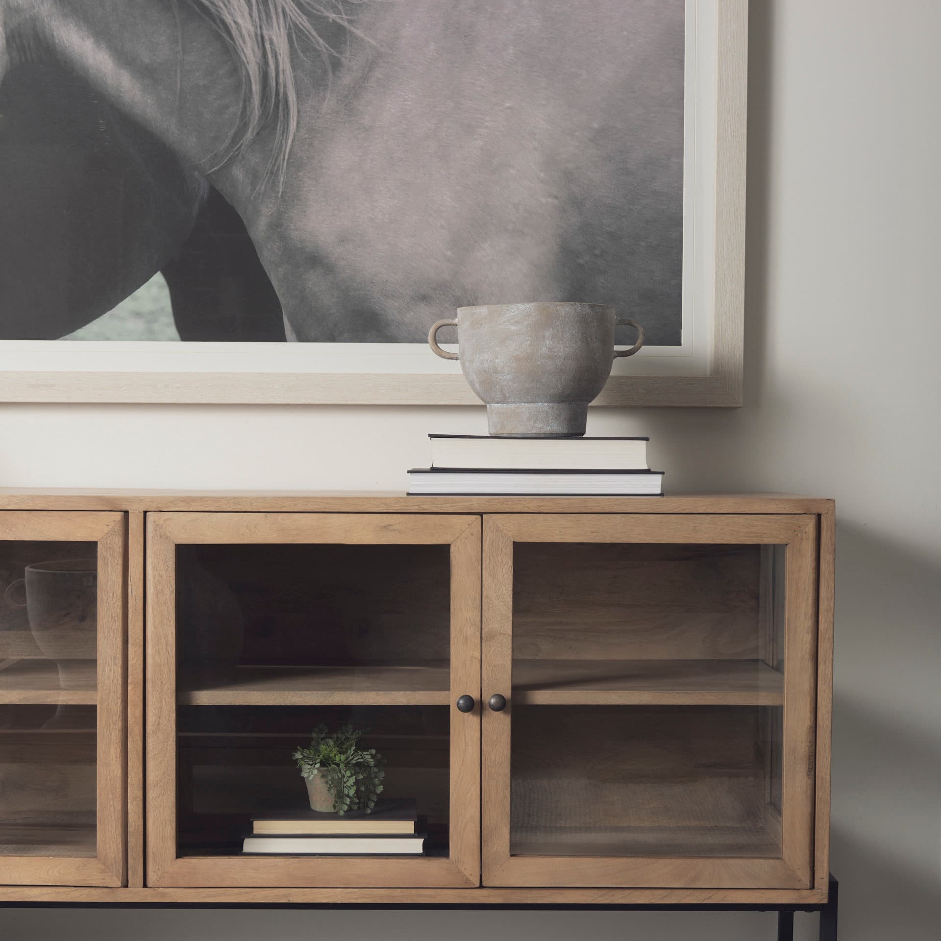 Arelius 70L x 18.75W x 32H Light Brown Wood, Black Metal Base w/ 4 Glass Cabinet Doors Sideboard — product photograph