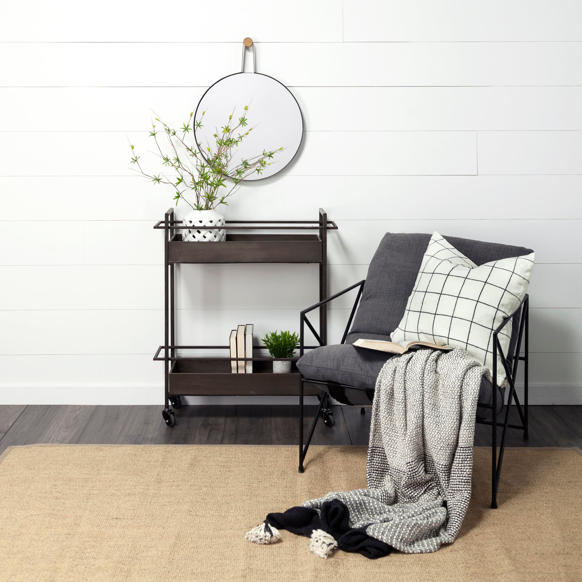 Collie 20x26 Round Black Metal Frame Mirror — in a styled room
