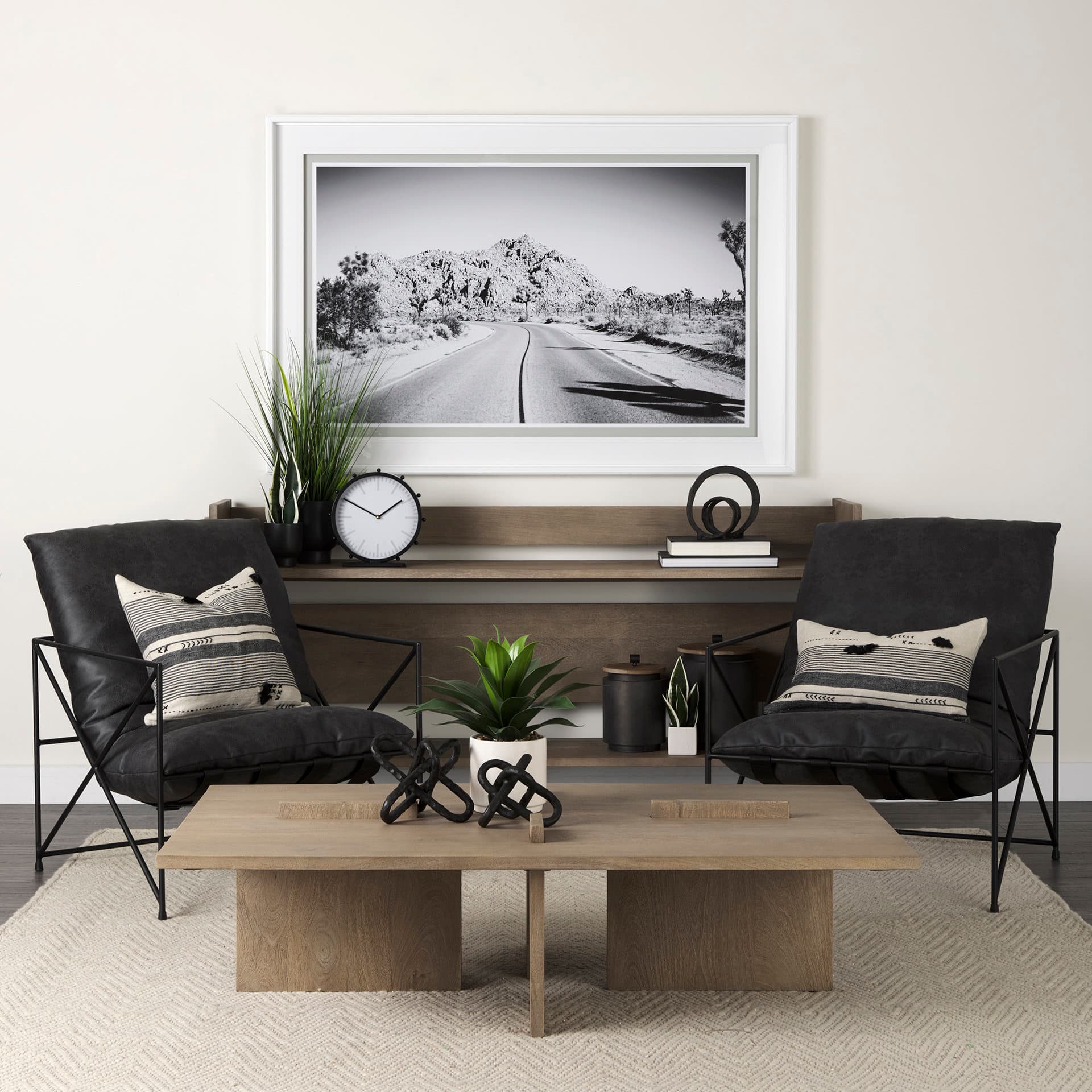 Marian 11.0L x 3.1W x 11.0H Black Studded Round Table Clock — in a styled room