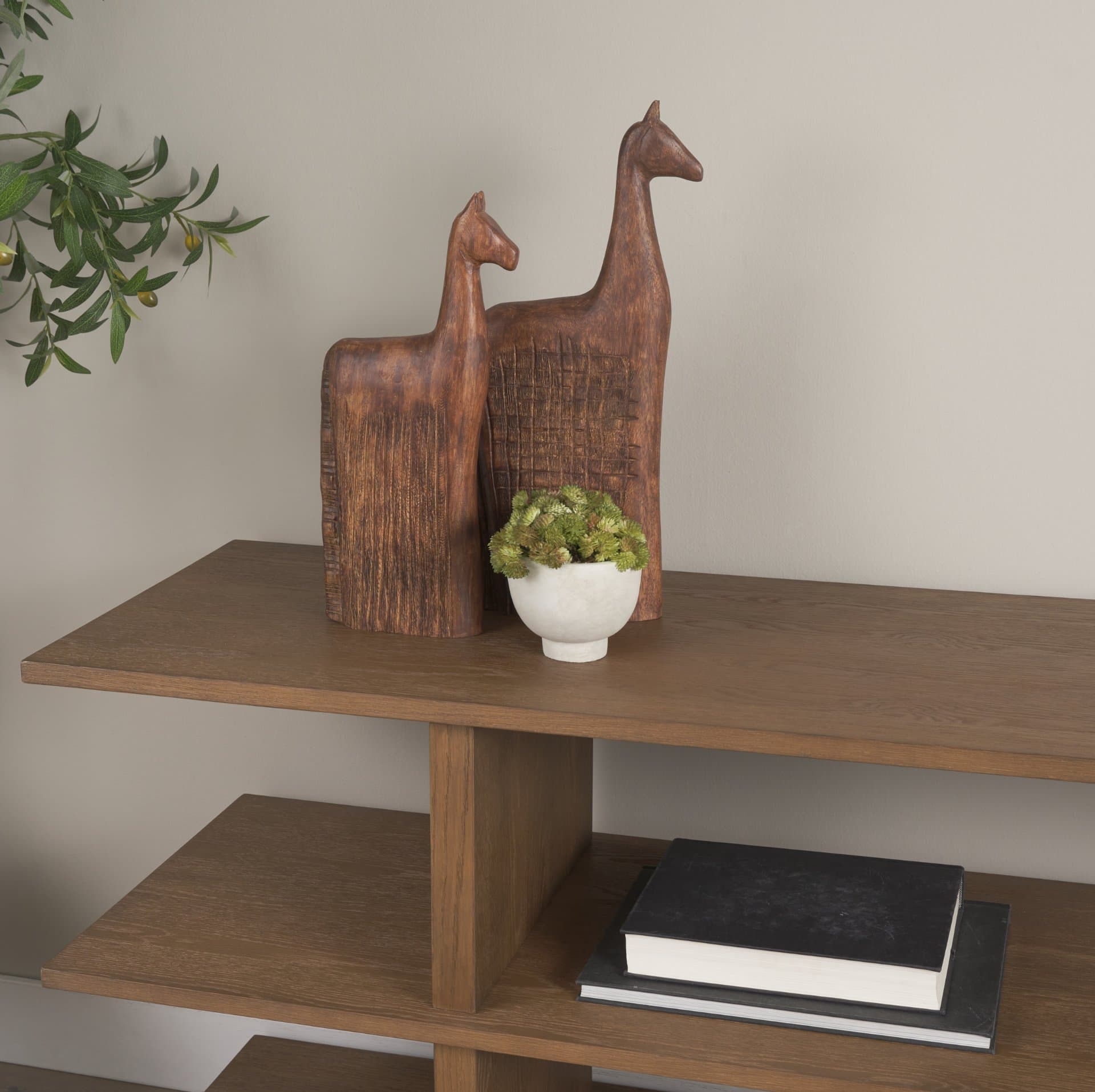 Farasi Medium Brown Wood Carved Horse Object (Set of 2) — in a styled room