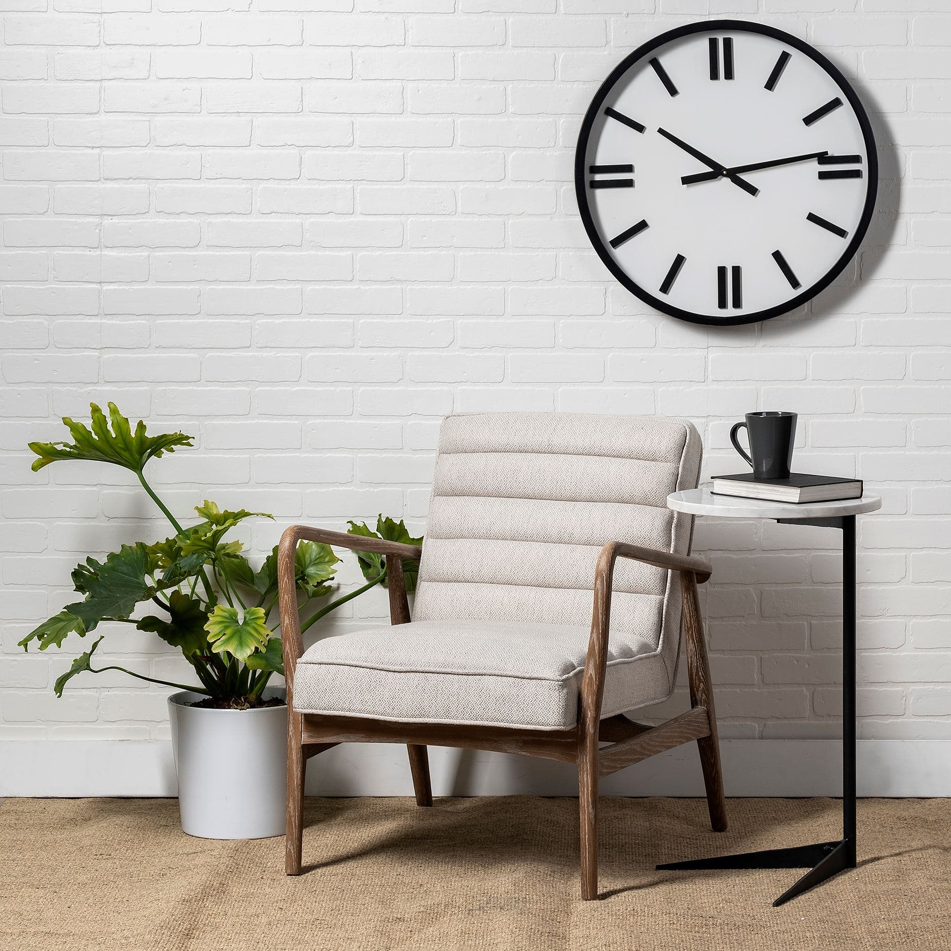 Derby 24" Round Oversize Modern Wall Clock — in a styled room