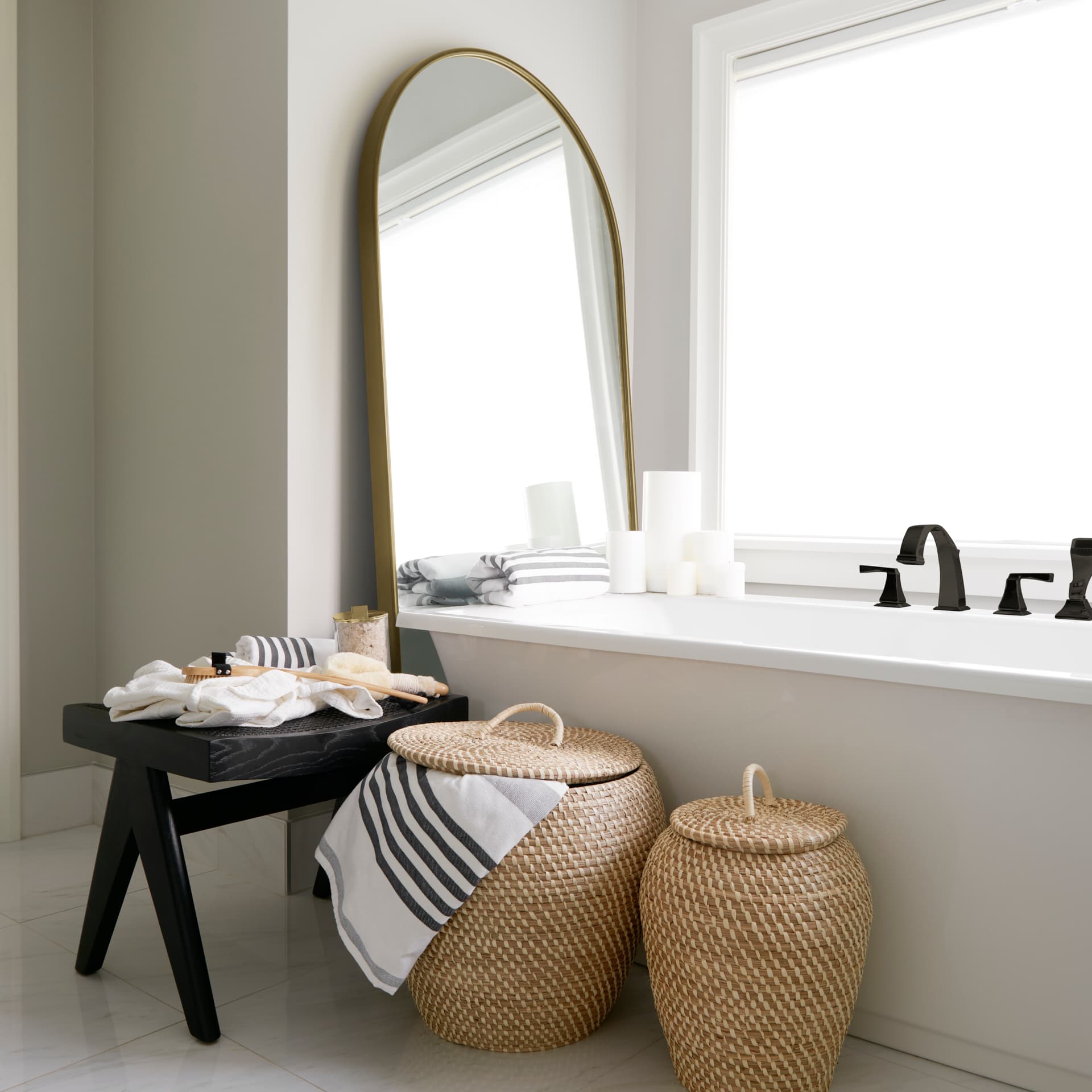Sadie 36.0L x 2.0W x 76.0H Antique Gold Metal Rounded Arch Floor Mirror — in a styled room