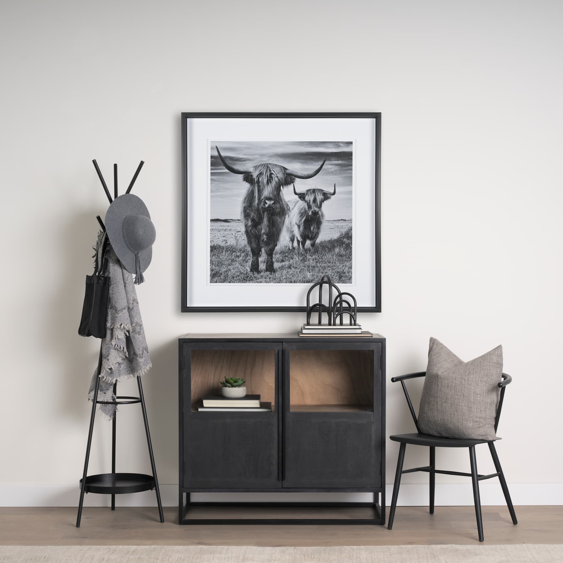 Everett Matte Black Metal w/ Two Metal Shelves Coat Rack — in a styled room