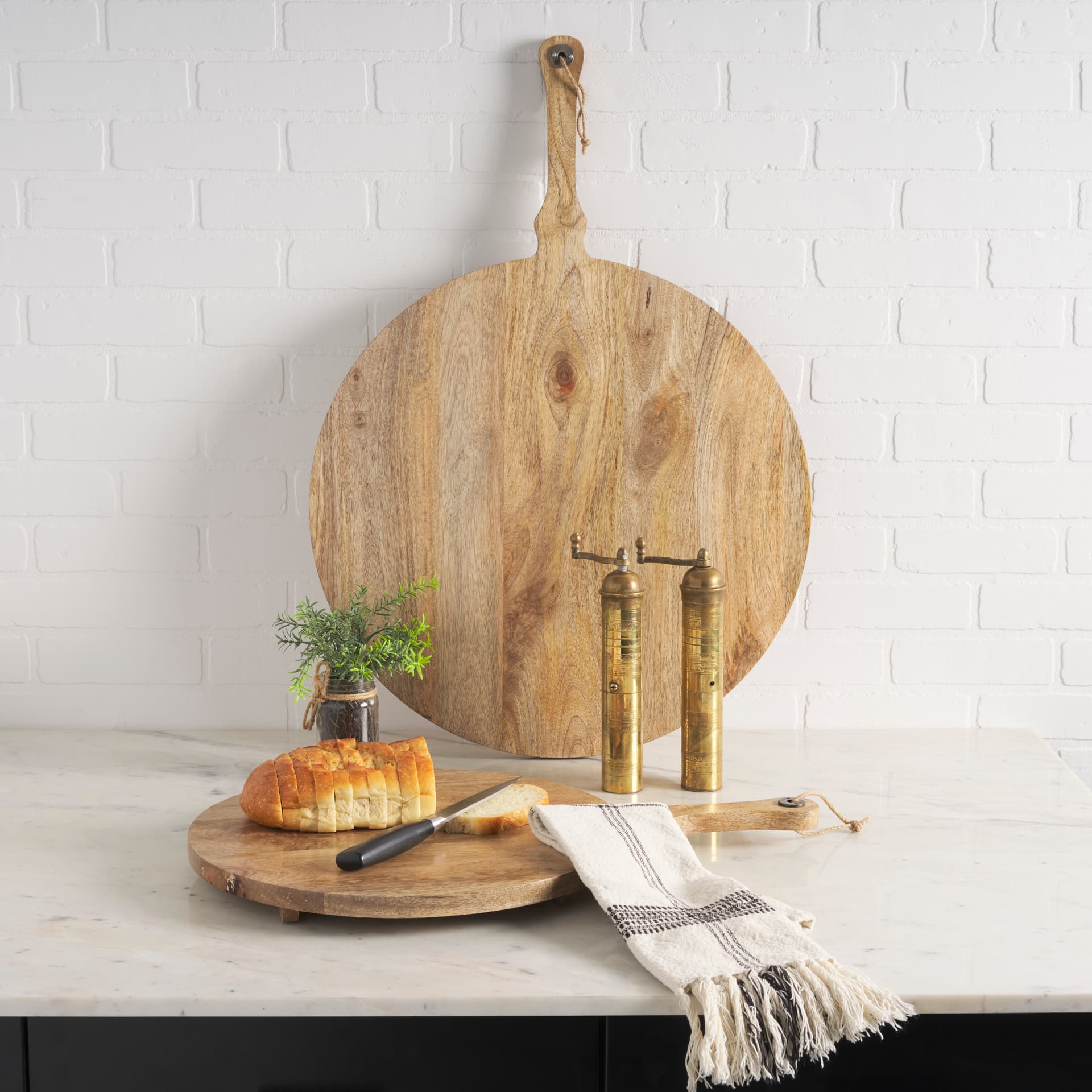 Karana Natural Solid Wood Round Serving Boards — in a styled room
