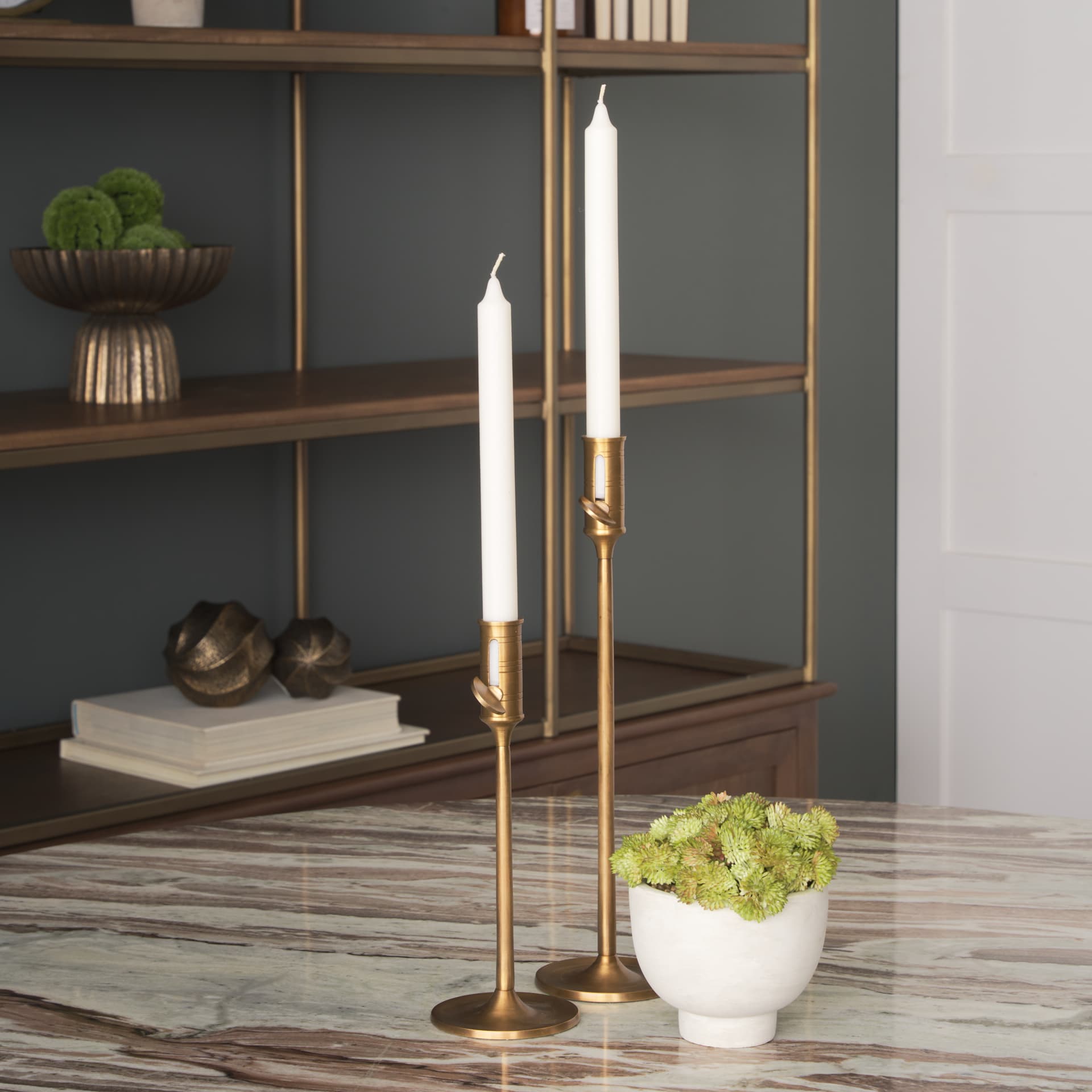 Chantria Small Solid Natural Brass Adjustable Taper Candle Holder — in a styled room