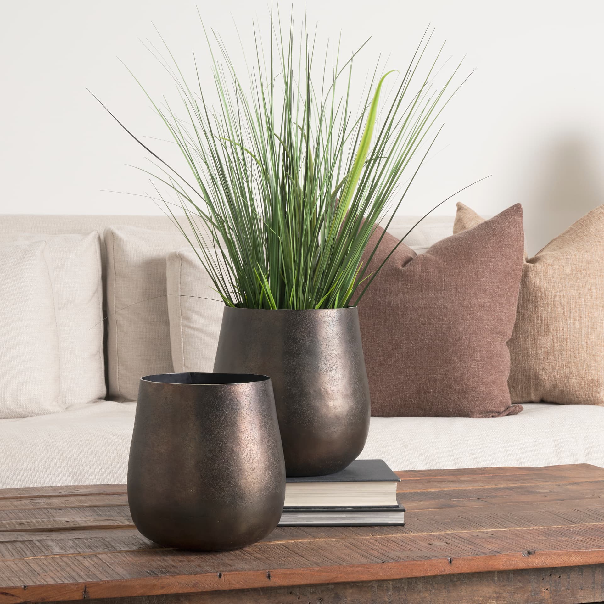 Quade Small Gold Metal Planter — in a styled room