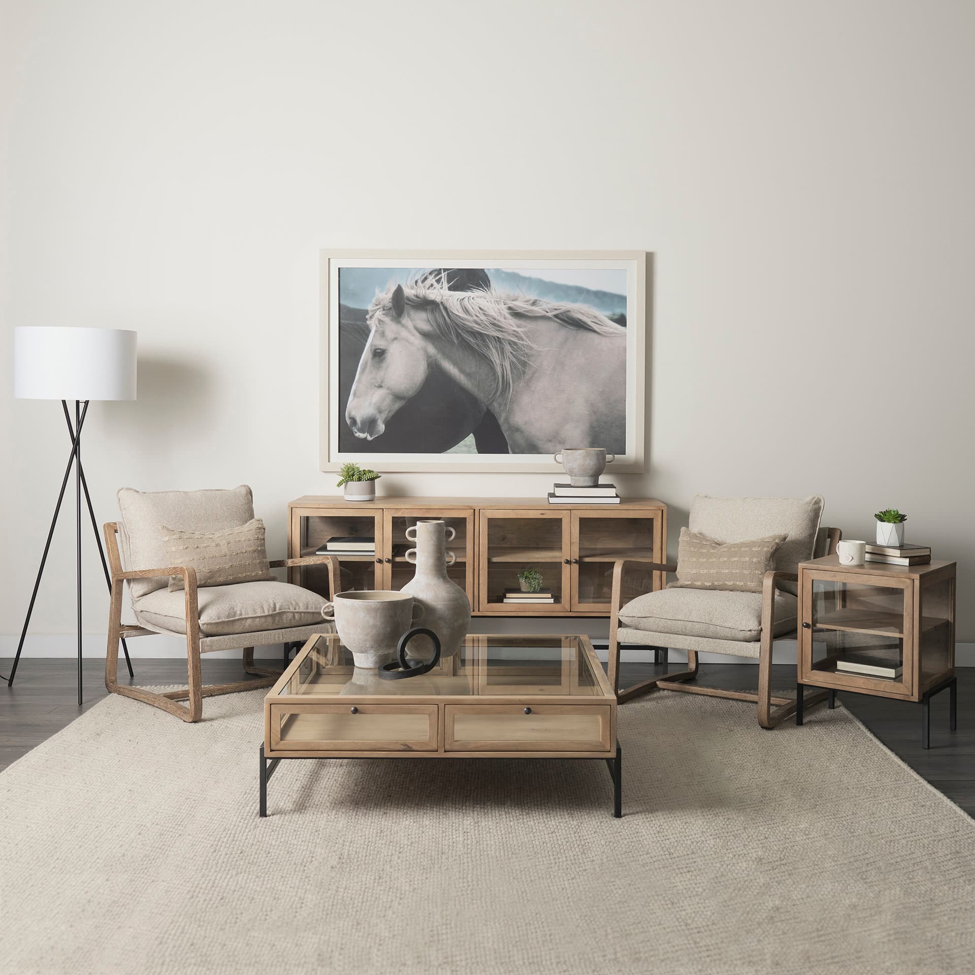 Arelius 70L x 18.75W x 32H Light Brown Wood, Black Metal Base w/ 4 Glass Cabinet Doors Sideboard — in a styled room